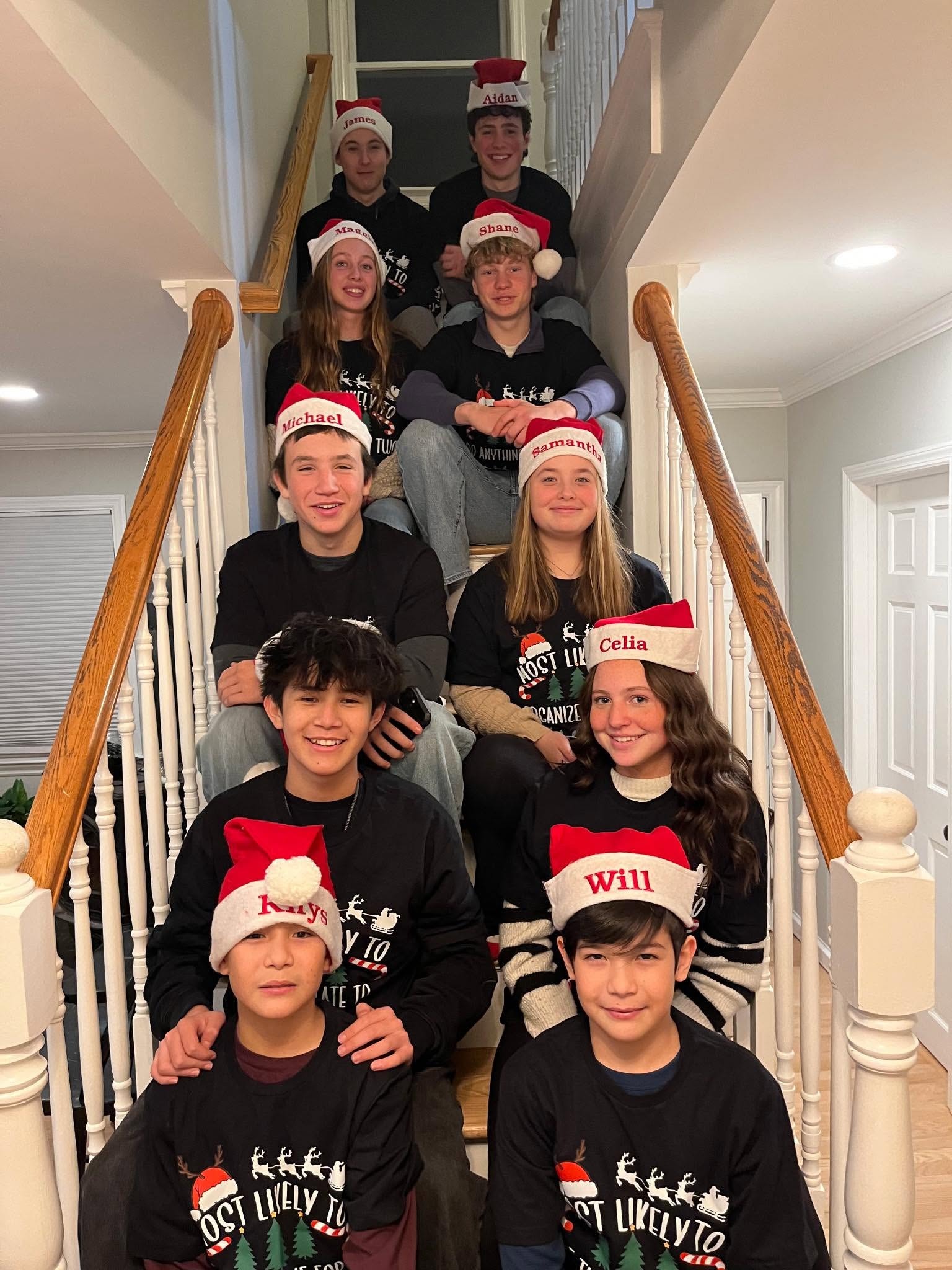 Mary Ann's 10 grandchildren in holiday sweaters on the stairs
